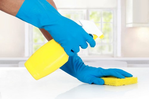 Office cleaning team maintaining desks and meeting room surfaces