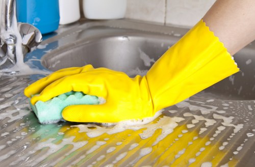 Person wiping the inside of an oven with a microfiber cloth